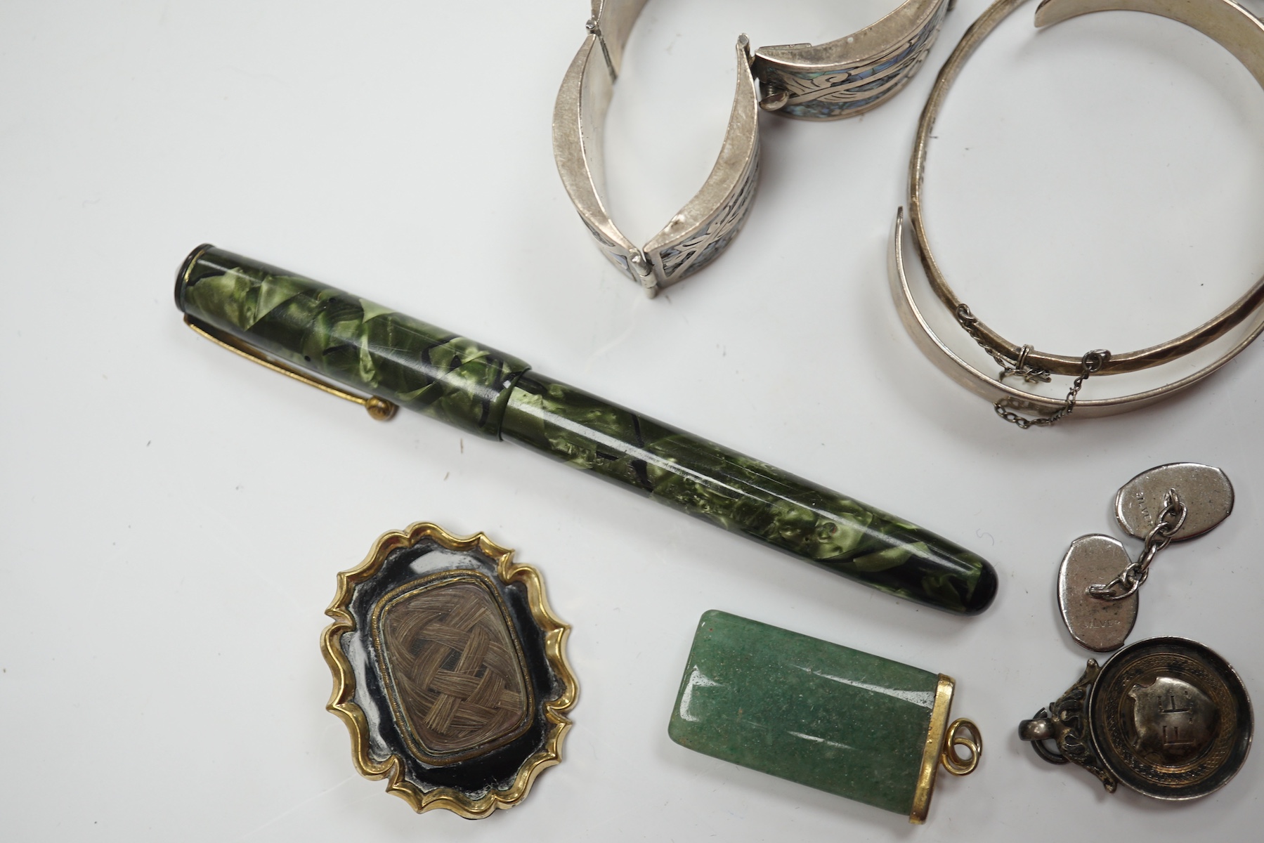 A mixed group of items including silver, white metal and costume jewellery, silver vesta case, silver mounted pepper mill, pens, Victorian mourning brooch, dress pocket watch, etc. Condition - poor to fair